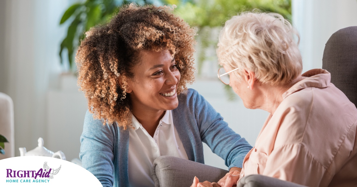 A caregiver warmly speaks with an older client, representing the quality communication that can come with bilingual care.