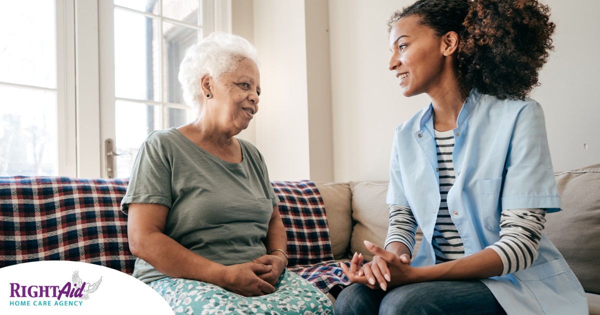A caregiver sits and spends time with a client, representing how non-medical home care can benefit older loved ones.