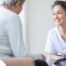 A woman smiles while with a client representing the pros of the home care industry.