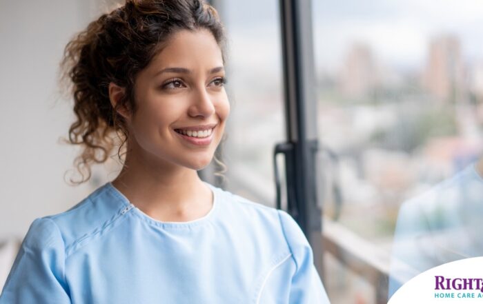 A woman smiles while looking ahead hopefully, showing the positive outlook that planning for a home care career can bring.