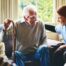 A woman has a good time with her older clients, representing the kind of personal skills needed to be a good caregiver.