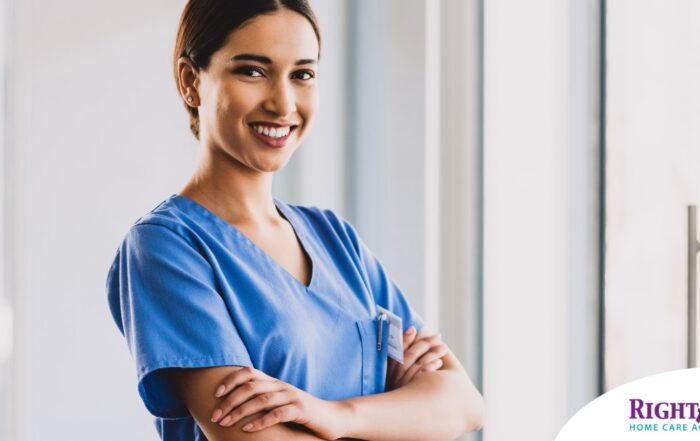 A woman in scrubs smiles representing the satisfaction of finding out how to become a home health aide.