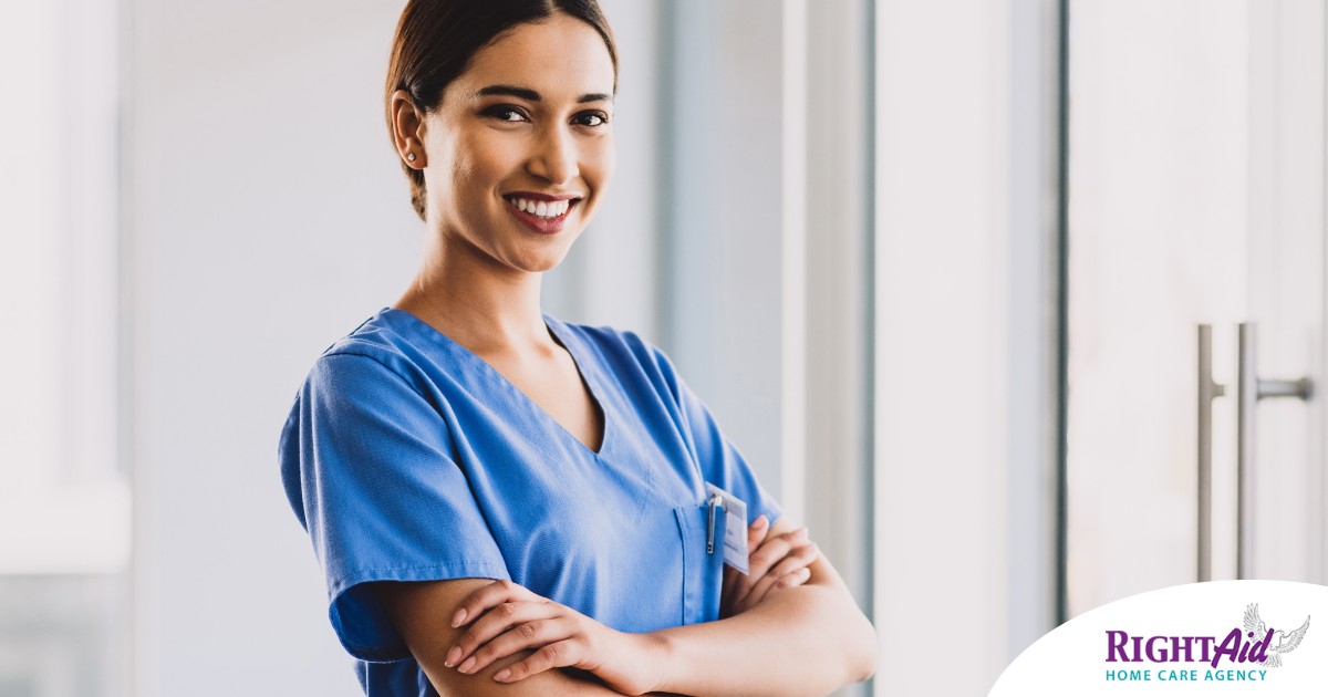 A woman in scrubs smiles representing the satisfaction of finding out how to become a home health aide.