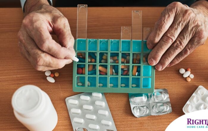 Older hands organize pills into a pill organizer, showing a great tool for managing medications.