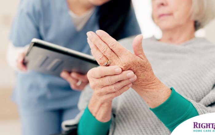 A caregiver providing in home care services to help manage a senior with arthritis