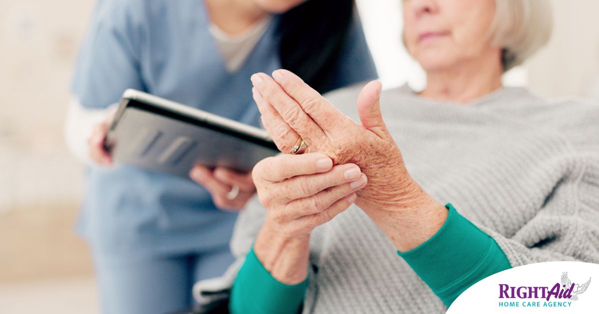 A caregiver providing in home care services to help manage a senior with arthritis